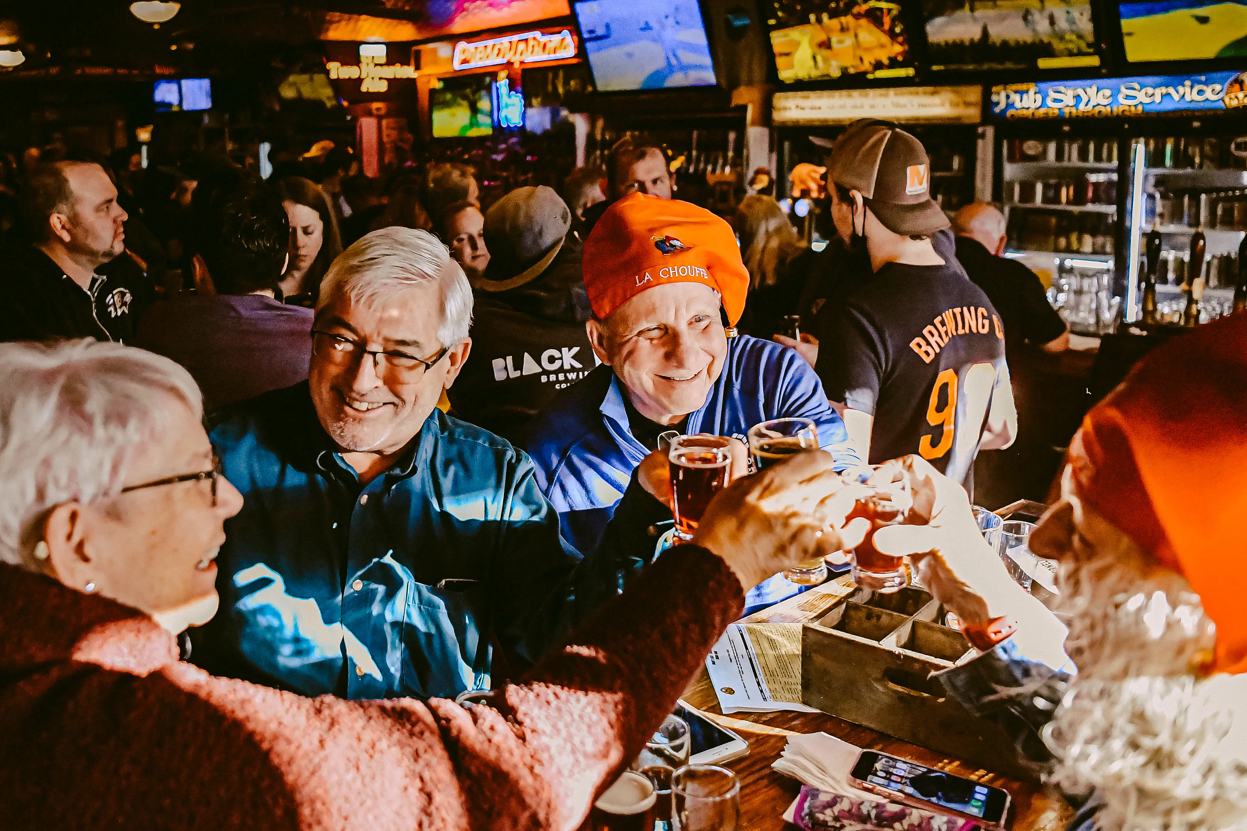 group of friends celebrating Belgian Fest with a toast of beer samples at Max's